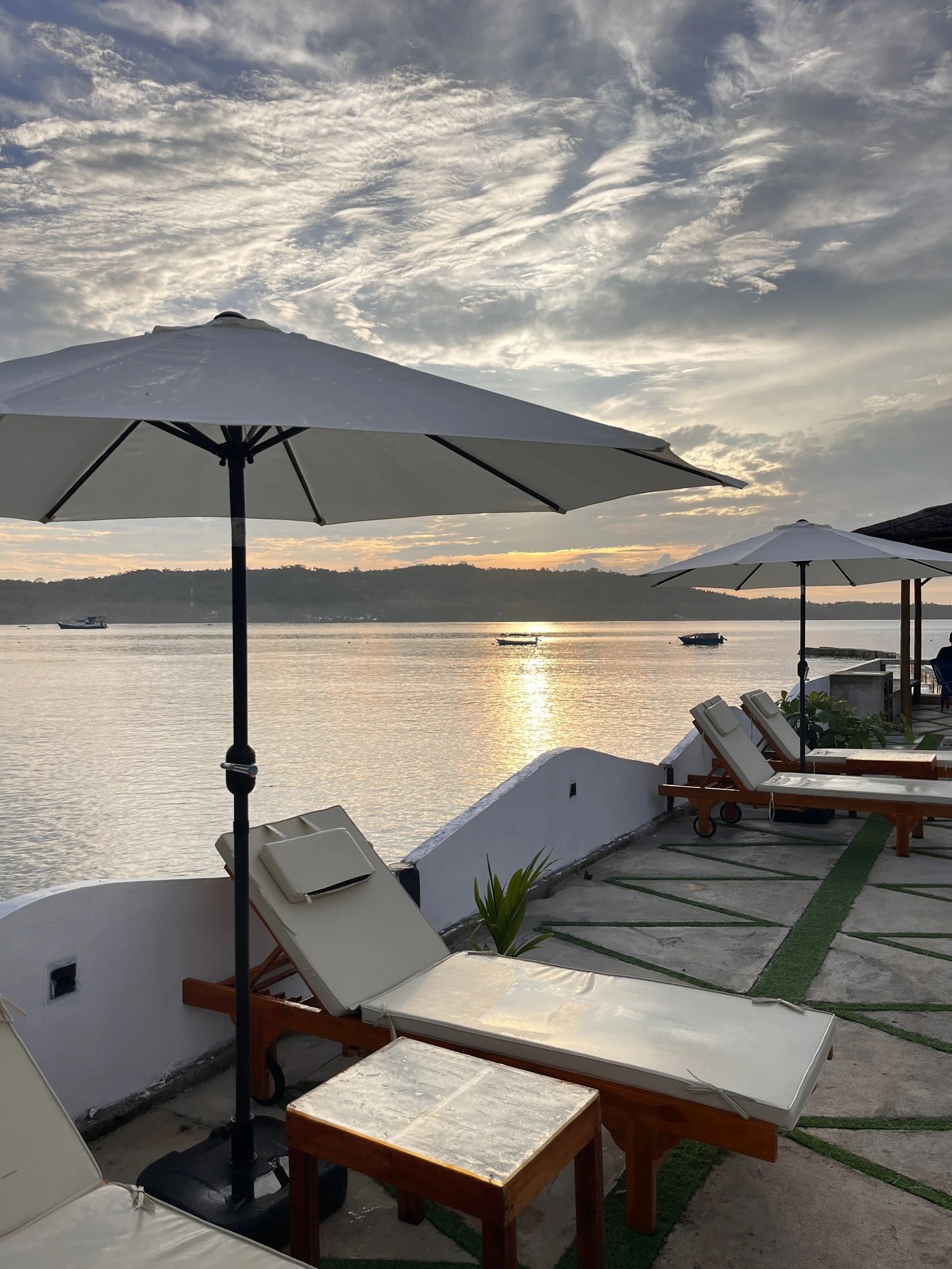 Beachfront sun loungers at Raffiel Nias, Sorake Beach at sunset